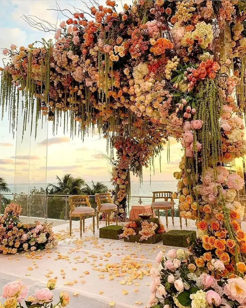 Haldi and mehendi farmhouse venue in Delhi NCR with a floral arch and petal-covered seating